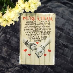 We're a Team metal sign